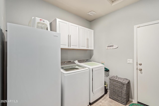 laundry area featuring cabinets and washing machine and clothes dryer