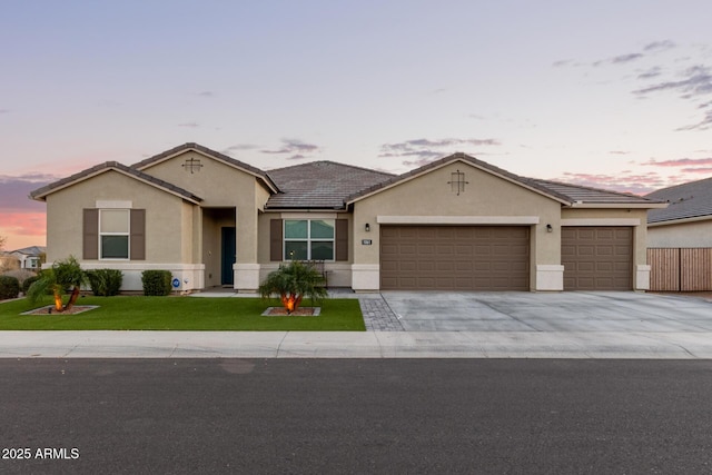 ranch-style home with a yard and a garage