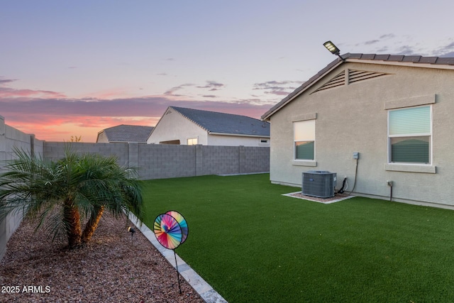 yard at dusk featuring cooling unit