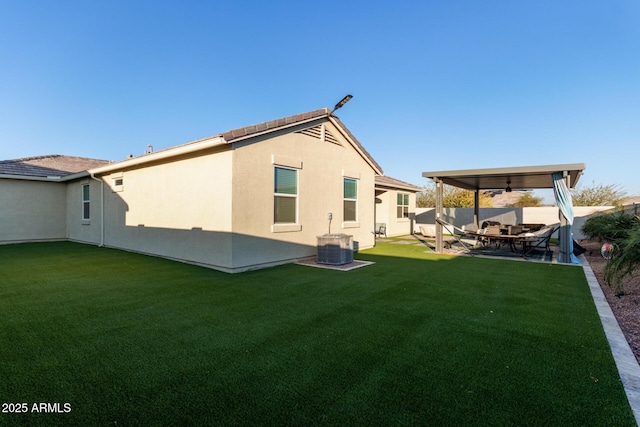 back of house with a patio, cooling unit, ceiling fan, and a lawn