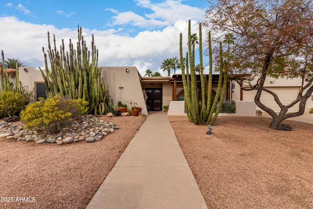 view of front of property featuring a garage and stucco siding