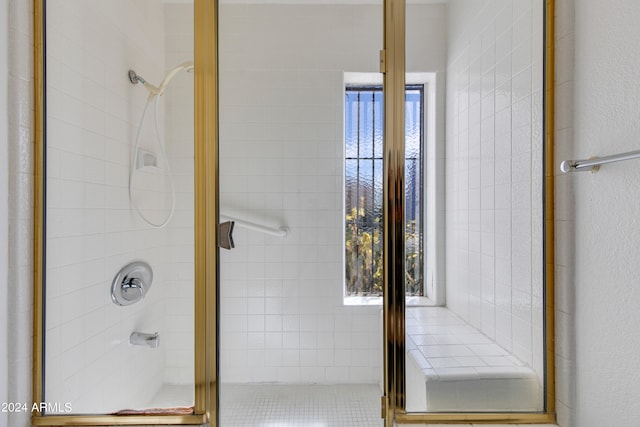 bathroom featuring a shower with door