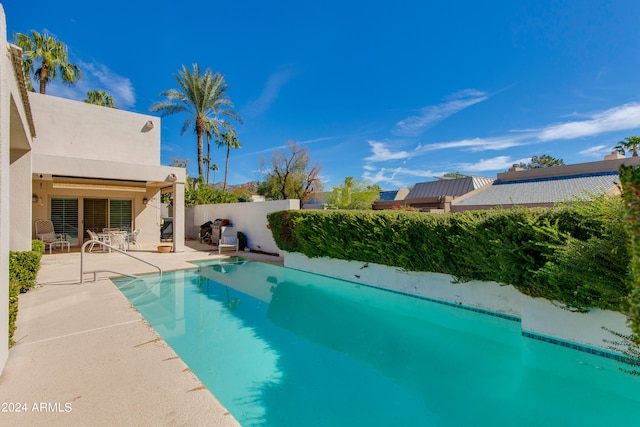 view of swimming pool with a patio