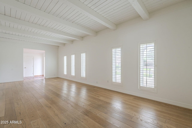 unfurnished room featuring a healthy amount of sunlight, light wood-style floors, and baseboards