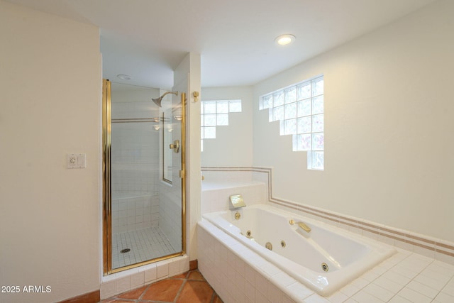 bathroom featuring a shower stall and a whirlpool tub