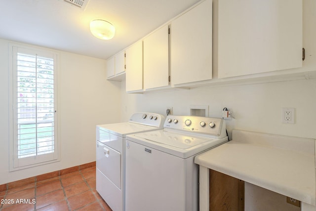 washroom with cabinet space, baseboards, a healthy amount of sunlight, and separate washer and dryer