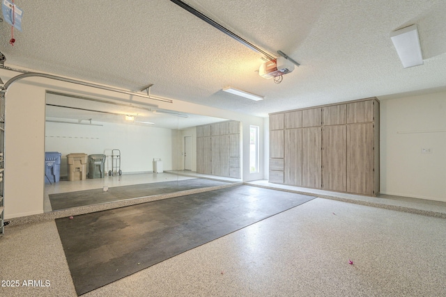 garage featuring a garage door opener and baseboards