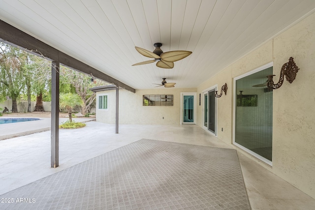 view of patio with a fenced in pool, ceiling fan, and fence