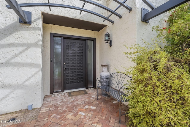 entrance to property with stucco siding