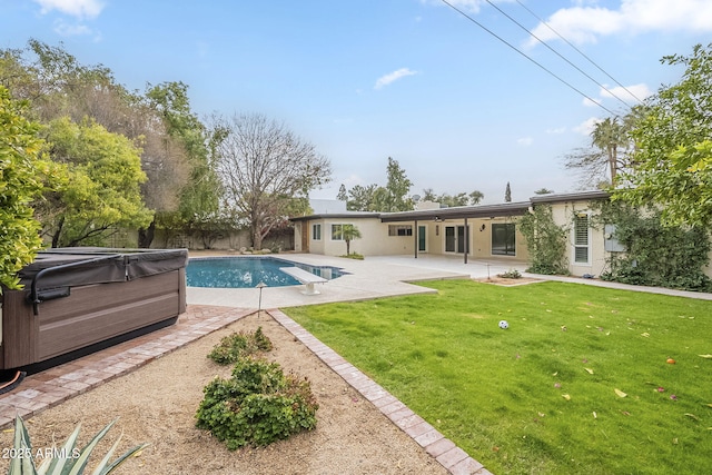 pool featuring a patio and a lawn