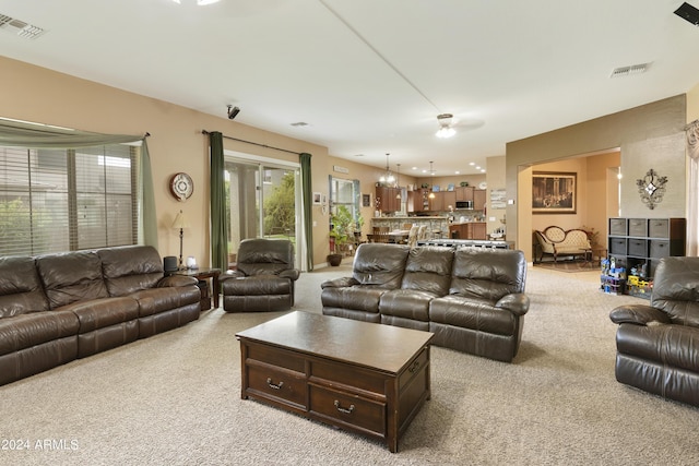 living room featuring visible vents and light carpet