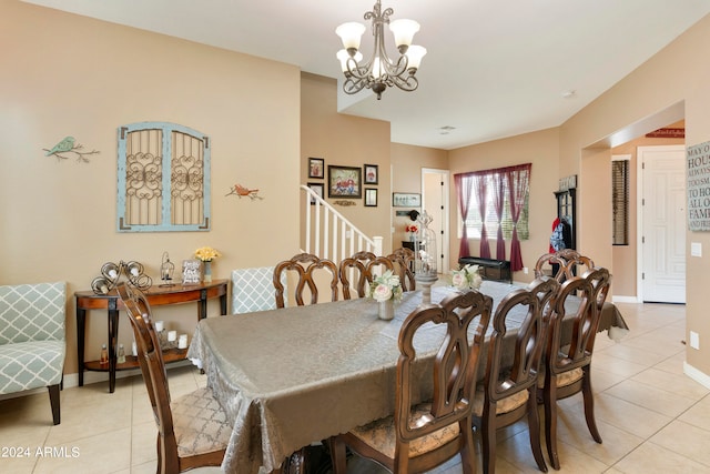 tiled dining space featuring an inviting chandelier