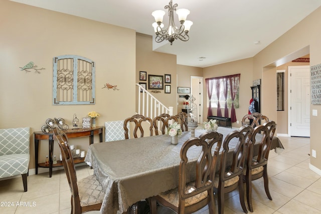 dining area featuring light tile patterned floors, baseboards, stairway, and a chandelier