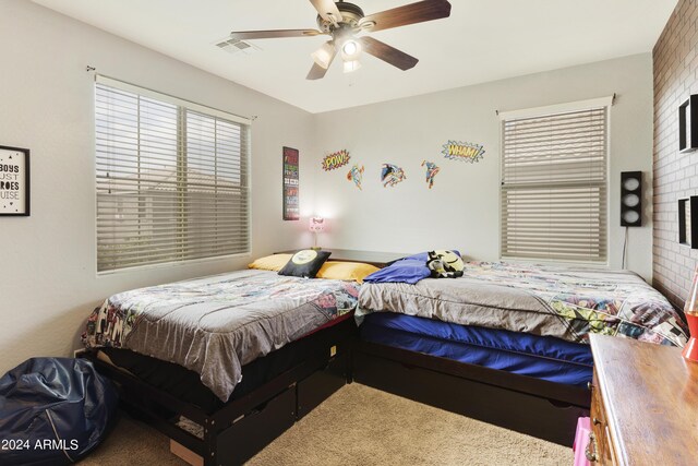 bedroom with brick wall, carpet floors, and ceiling fan