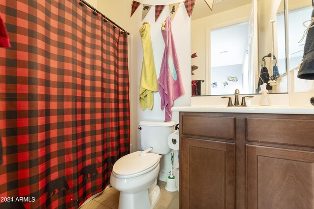 bathroom featuring vanity, toilet, a wealth of natural light, and tile patterned flooring