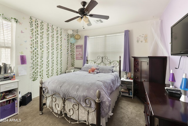 bedroom featuring carpet floors, visible vents, and a ceiling fan