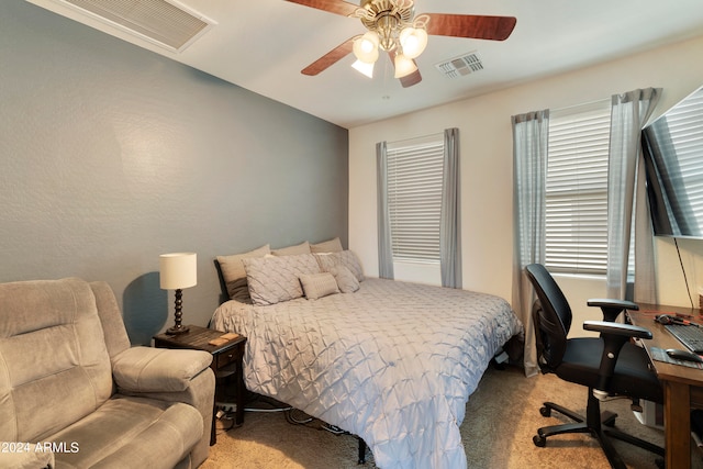 carpeted bedroom with multiple windows and ceiling fan