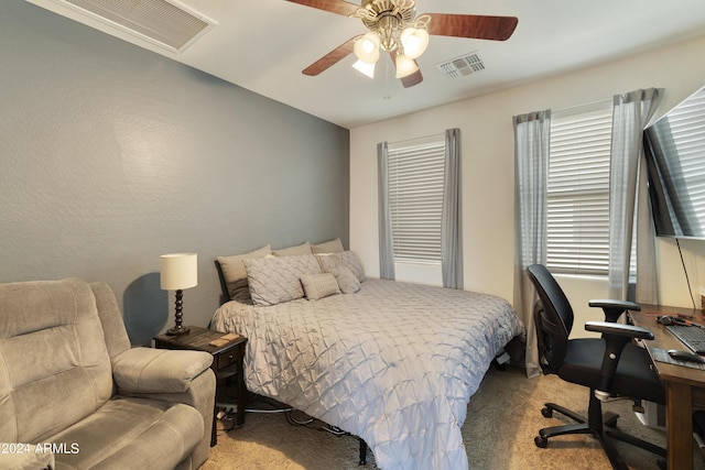 bedroom with light carpet, ceiling fan, and visible vents