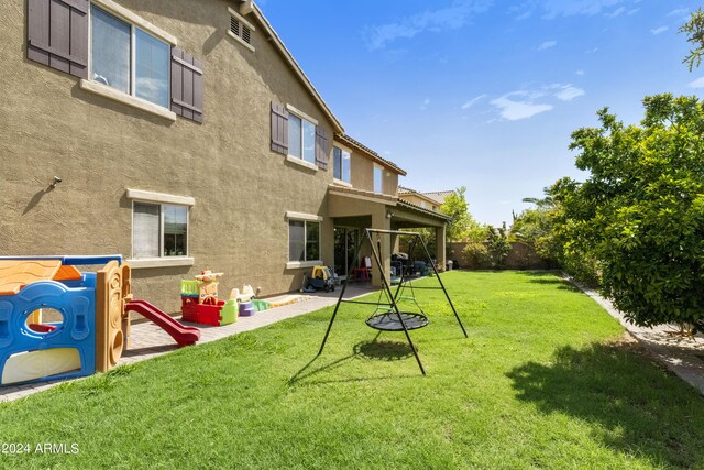 view of yard with a patio and a playground