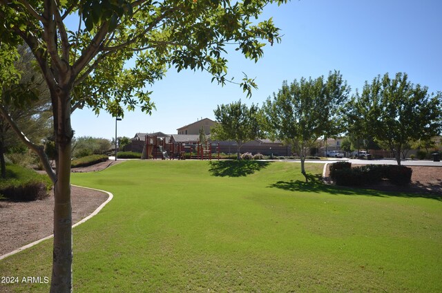 view of property's community featuring a playground and a lawn