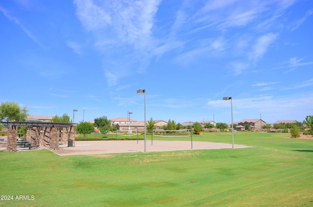 view of home's community featuring a lawn and volleyball court