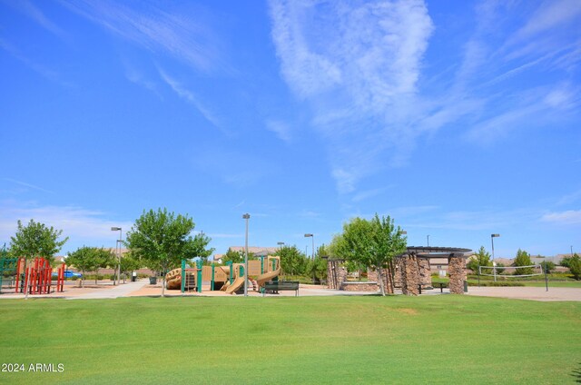 surrounding community with a playground, a yard, and volleyball court