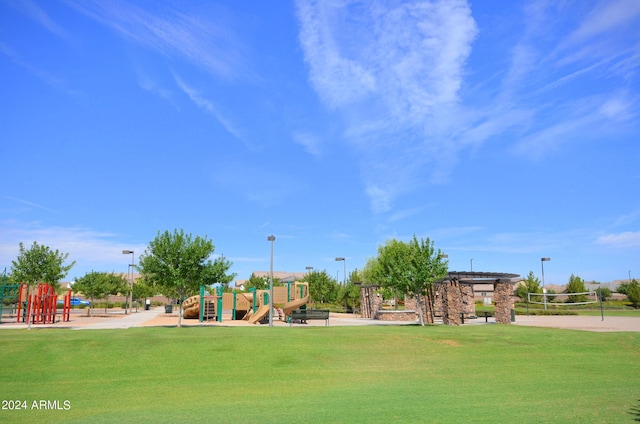 community play area featuring a lawn and volleyball court