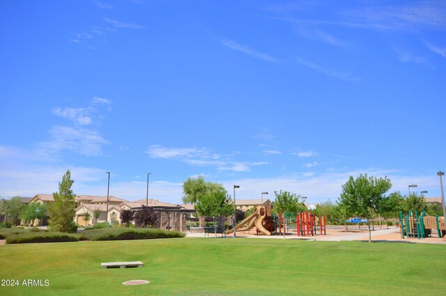 exterior space with a yard and a playground