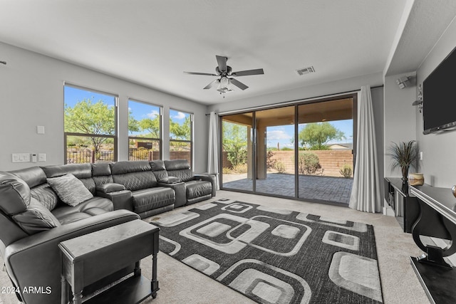 living room with ceiling fan, carpet, and visible vents