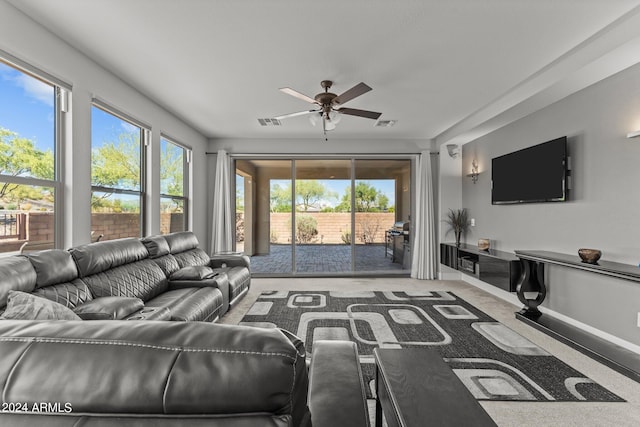 living room featuring plenty of natural light, carpet flooring, and ceiling fan