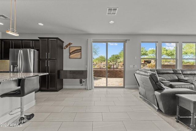 tiled living room featuring a wealth of natural light