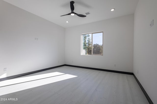 empty room featuring ceiling fan and light hardwood / wood-style floors