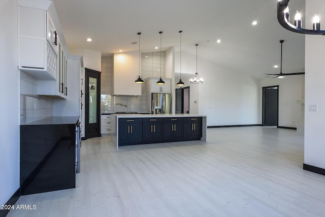 kitchen with decorative light fixtures, white cabinetry, tasteful backsplash, and a large island