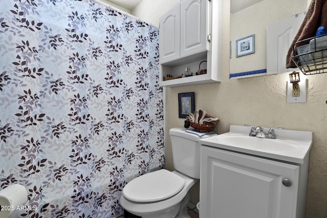 bathroom with vanity, curtained shower, and toilet