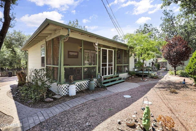 view of property exterior featuring a sunroom