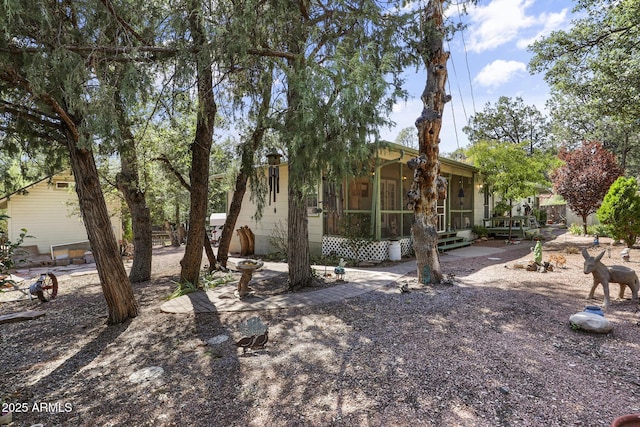 rear view of house featuring a sunroom