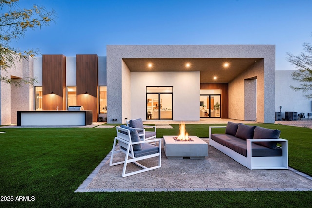 6584 E Gold Dust Ave, Paradise Valley, AZ 85253 - back of property featuring an outdoor living space with a fire pit, cooling unit, a yard, a patio, and stucco siding