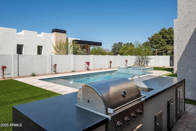 6584 E Gold Dust Ave, Paradise Valley, AZ 85253 - view of swimming pool with exterior kitchen, a fenced backyard, a patio area, grilling area, and a pool with connected hot tub