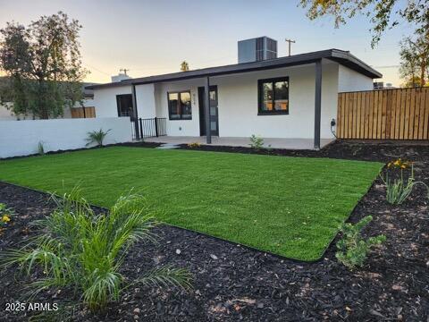 954 E Henry St, Tempe, AZ 85288 - back of property at dusk with stucco siding and central air condition unit