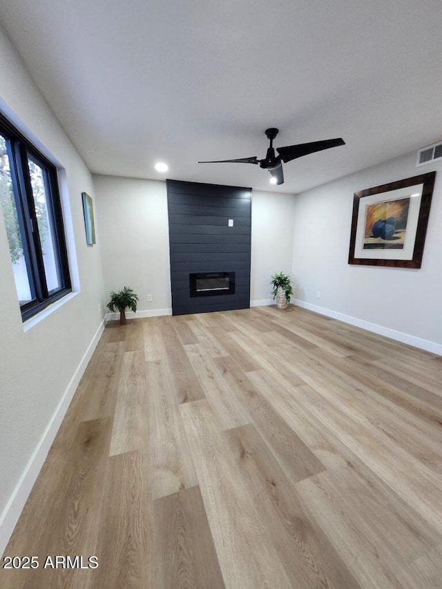 954 E Henry St, Tempe, AZ 85288 - unfurnished living room with light wood-type flooring, baseboards, a ceiling fan, a fireplace, and recessed lighting