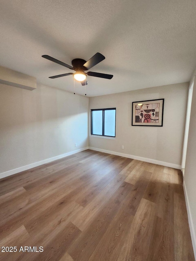 954 E Henry St, Tempe, AZ 85288 - spare room with a ceiling fan, a textured ceiling, wood finished floors, and baseboards