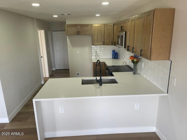 954 E Henry St, Tempe, AZ 85288 - kitchen featuring stainless steel microwave, a sink, a peninsula, stove, and light countertops