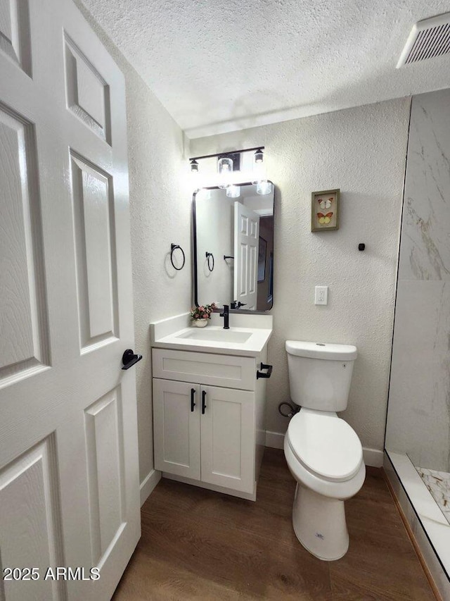 954 E Henry St, Tempe, AZ 85288 - bathroom with a textured wall, a textured ceiling, wood finished floors, toilet, and vanity