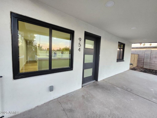 954 E Henry St, Tempe, AZ 85288 - view of exterior entry with a patio area, stucco siding, and fence
