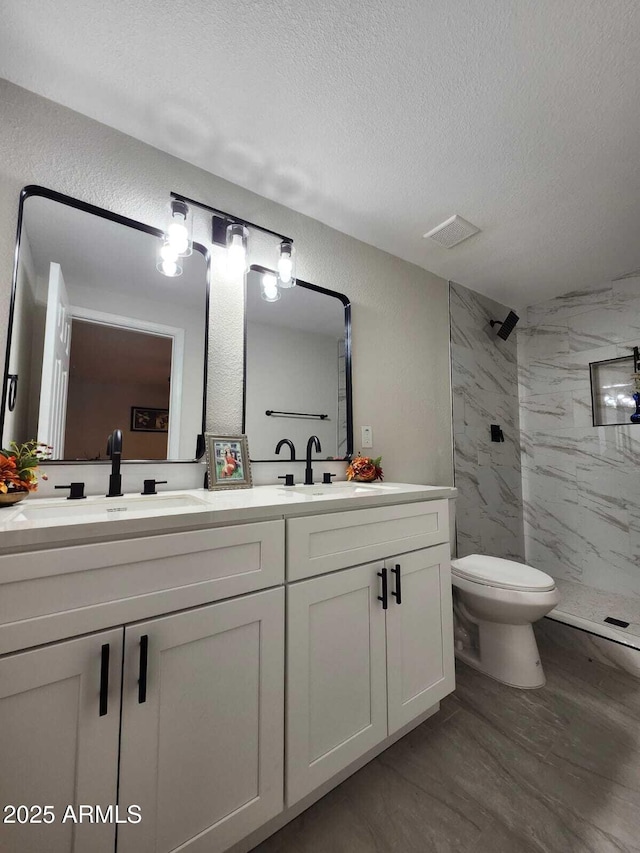954 E Henry St, Tempe, AZ 85288 - full bath featuring a textured ceiling, a marble finish shower, double vanity, toilet, and wood finished floors