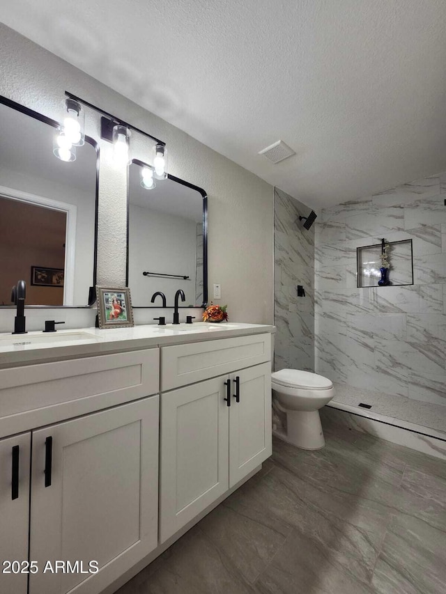 954 E Henry St, Tempe, AZ 85288 - bathroom featuring a textured ceiling, a marble finish shower, double vanity, and toilet
