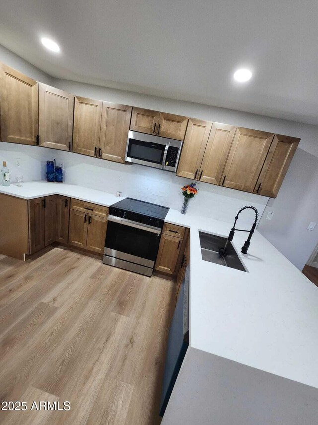 954 E Henry St, Tempe, AZ 85288 - kitchen featuring appliances with stainless steel finishes, a sink, light wood-style flooring, light countertops, and recessed lighting