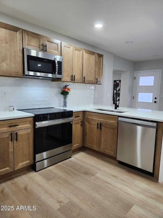 954 E Henry St, Tempe, AZ 85288 - kitchen with appliances with stainless steel finishes, light wood-style floors, backsplash, light countertops, and recessed lighting
