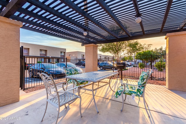 patio terrace at dusk featuring a pergola