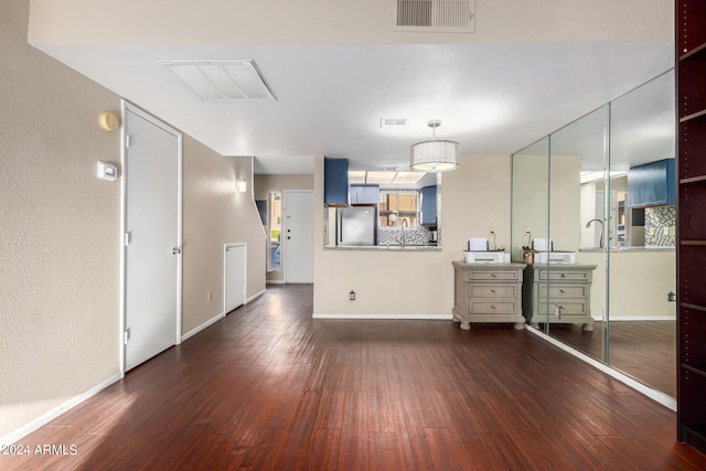 kitchen featuring stainless steel fridge, dark hardwood / wood-style flooring, and sink